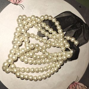 Faux pearl strings with black lace tie -ups